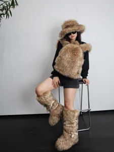 Detail shot of women's faux fur snow boots with punk buckles and matching plush hat.