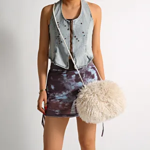 Detailed view of white faux fur crossbody bag with fluffy cloud texture and thin strap