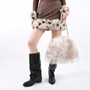 Detail of a large white faux feather cloud bag featuring a gold chain strap for women