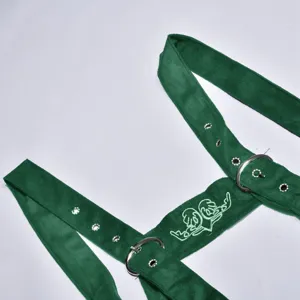 Green velvet Oktoberfest suspender harness detail shot with metal buckles and embroidery.