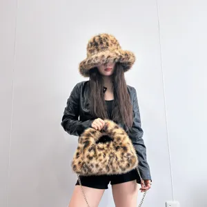 Stylish leopard print faux fur bucket hat and matching hobo bag set for winter fashion.