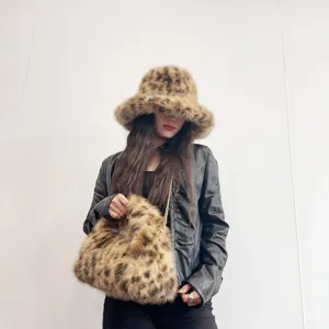 Fashionable faux fur leopard print bucket hat and matching hobo bag worn by model