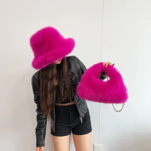 Vibrant hot pink faux fox fur bucket hat and matching hobo bag set worn by model