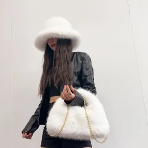 Close-up of fluffy white faux fox fur bucket hat and matching hobo bag with chain