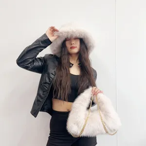 Close-up detail of the pink faux fur bucket hat and matching gold chain hobo bag fashion set