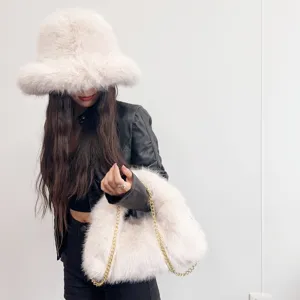 Stylish set with off-white faux fur bucket hat and matching chain hobo bag for winter.