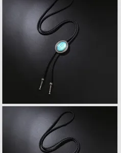 Close-up detail of vintage bolo tie featuring a blue gemstone and braided black leather cord