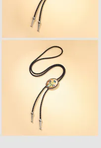 Detailed view of a western cowboy bolo tie with an oval patterned alloy pendant.