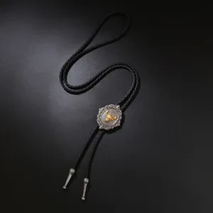 Vintage western bolo tie for men with a golden bull head motif on black braided cord