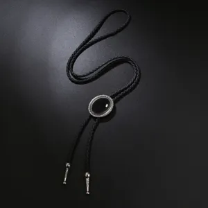 Vintage black gemstone bolo tie with braided leather cord and silver-tone tips