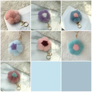 Collection of colorful mink fur flower keychains with gold metal rings and heart charms