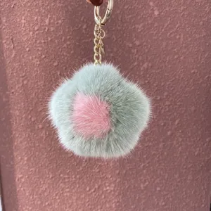 Close-up showing the soft mink fur texture of a green and pink flower keychain pendant