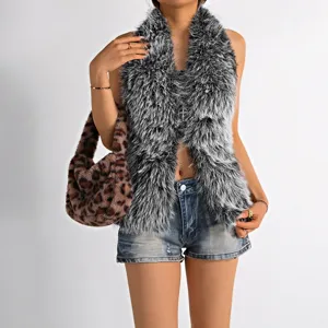 Detail of grey Mongolian faux fur halter top with cross necklace and backless design.