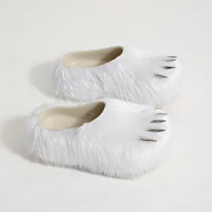 Detailed view of white faux fur claw slippers with metallic spikes and platform sole