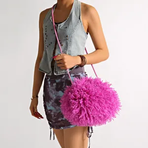 Vibrant pink fuzzy lamb fur cloud crossbody bag styled with denim fashion