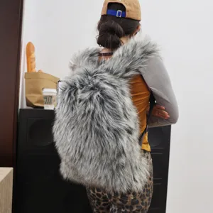 Oversized grey faux raccoon fur backpack for Y2K fashion street style lifestyle shot