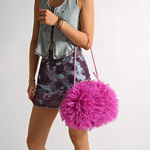 Pink fluffy faux fur handbag in a round cloud shape with thin shoulder strap