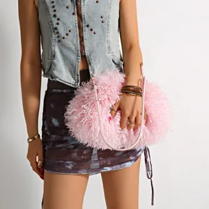 Macro detail of soft pink faux Mongolian lamb fur on stylish cloud shaped shoulder handbag