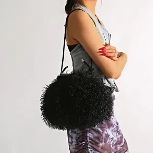 Detailed view of black faux Mongolian sheep fur cloud bag with long shaggy texture.