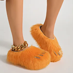 Detailed view of fluffy orange animal claw slippers with silver nails and platform sole.
