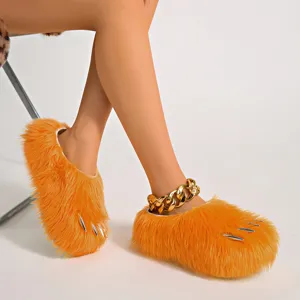 Detailed close-up of orange fluffy paw slippers with silver claws and thick platform sole
