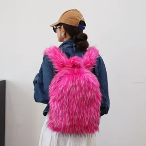 Stylish hot pink faux fur Y2K backpack worn by model, showing fluffy texture and size