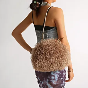 Plush imitation lamb fur cloud bag in khaki shown on model as a chic underarm bag
