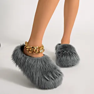 Close-up of grey furry claw slippers with silver claws and thick platform sole