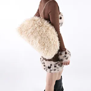 Detail of large faux Mongolian lamb fur cloud bag with soft fluffy texture and chain strap.