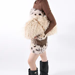 Detail view of large fluffy cloud bag with curly cream faux fur and elegant gold chain strap
