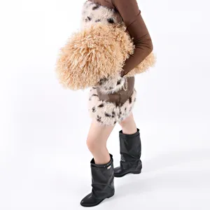 Elegant oversized curly faux fur cloud clutch bag in tan featuring a gold chain strap
