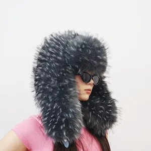 Detailed side view of a grey fluffy faux raccoon fur trapper hat in Y2K style on a model