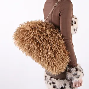 Large curly faux fur cloud bag with gold chain strap detail view on model 2026