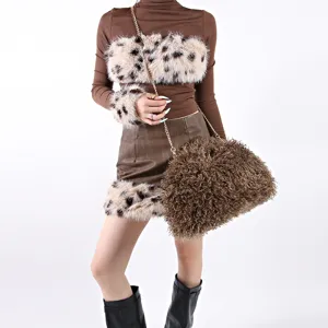 Detail view of a large brown shaggy lamb hair cloud bag with elegant gold chain strap