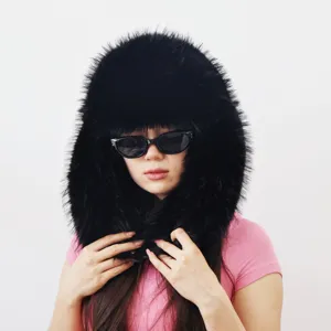Close-up of fluffy black faux raccoon fur trapper hat on Asian model in Y2K spicy girl style