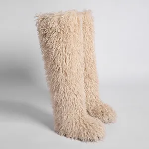 Detalle del pelo sintético de cordero de Mongolia en botas de nieve por encima de la rodilla