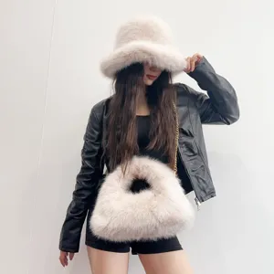Chic plush faux fur bucket hat and matching hobo bag set for a stylish winter accessory.