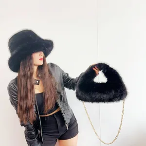 Stylish black faux fox fur bucket hat and hobo bag set with elegant gold chain