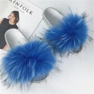 Close-up detail of silver PVC slides with lush blue raccoon fur trim