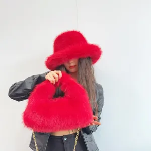 Detailed view of luxury red faux fox fur bucket hat and matching hobo bag set style