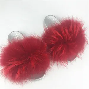 Close-up detail of silver PVC sole slippers featuring vibrant red raccoon and fox fur