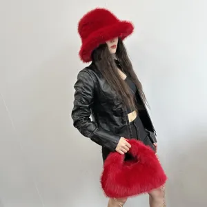 Fashion model wearing a trendy red faux fur bucket hat and matching hobo bag set.