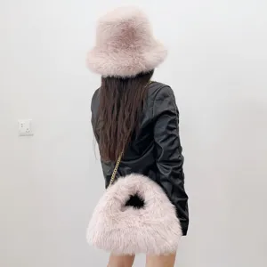 Back view showing soft faux fur texture of the pink bucket hat and matching hobo bag
