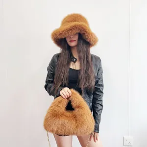 Detail of luxurious brown faux fur bucket hat and matching hobo bag set worn by model