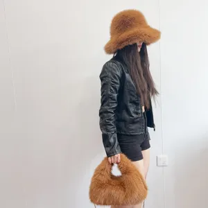 Stylish brown faux fox fur bucket hat and matching fluffy hobo bag set on model