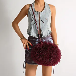 Detailed view of a stylish burgundy faux lamb fur fluffy spherical crossbody bag for women
