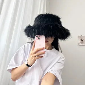 Detailansicht eines schwarzen Kunstpelz-Fischerhuts in einem minimalistischen Spiegel-Selfie.