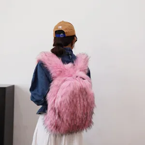Rear view of a model wearing a pink oversized Y2K faux fur backpack