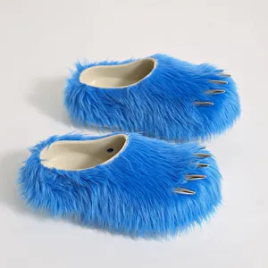 Macro view of blue faux fur mule slippers featuring decorative silver metallic claws