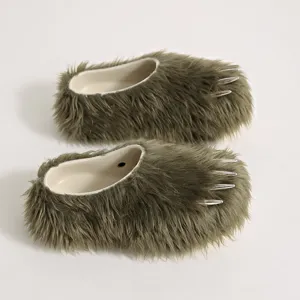 Detailed view of green furry monster claw slippers featuring silver claw decorations